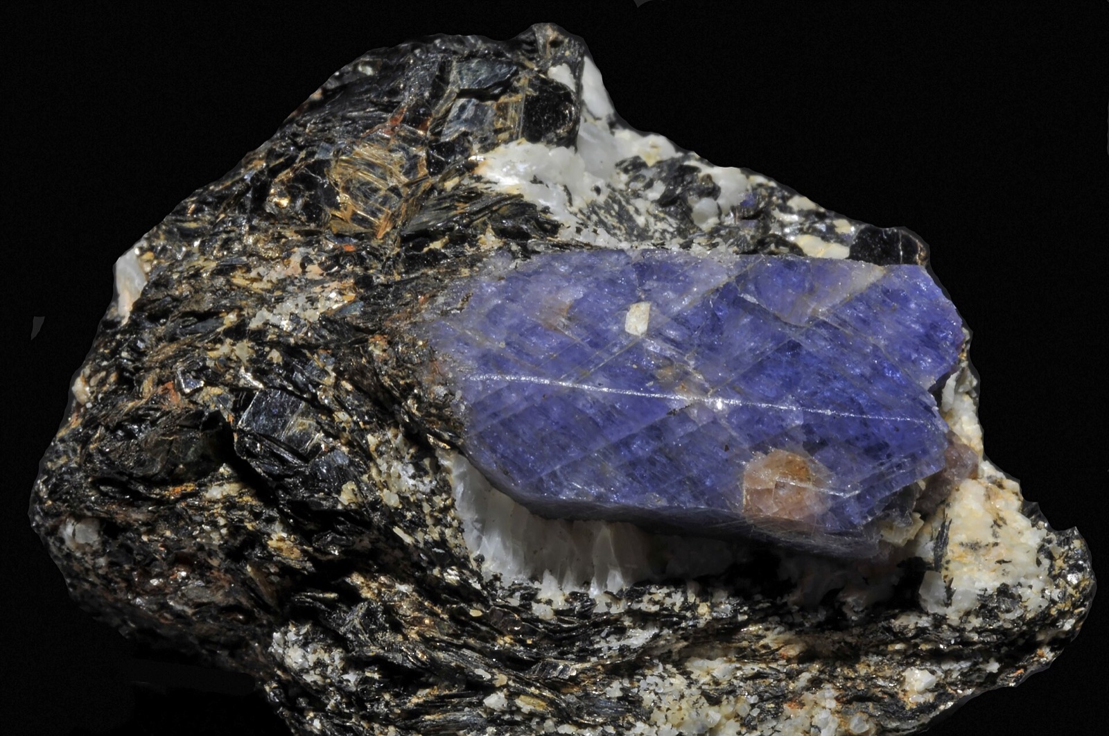 Blue sapphire crystal in dark biotite rock with amazonite, Zazafotsy quarry, Madagascar
